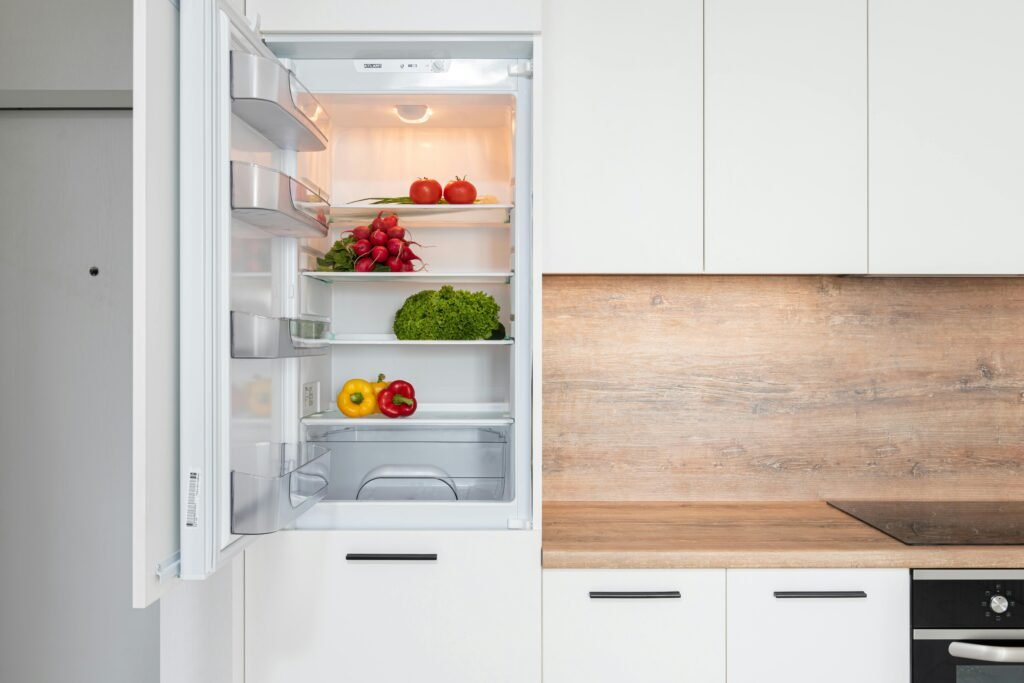 pexels photo 6508357 6508357 Open fridge in a sleek kitchen with fresh vegetables, perfect for healthy meals.